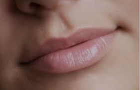 Close-up of smooth, hydrated lips with a glossy finish, showcasing the results of effective Treatments for Lip Lines