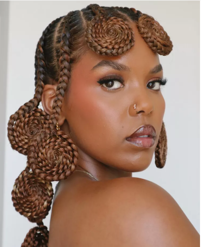 10 Protective Hairstyles for Spring That’ll Have You Serving Looks All Season 3 A woman flaunting a trendy spring protective hairstyle, featuring flawless braids and twists, perfect for spring’s fresh and stylish vibe.