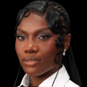 Doechii stuns in micro braids at the Billboard Women in Music Awards, paired with a sheer gown and glowing makeup.