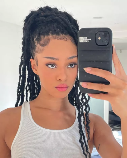10 Protective Hairstyles for Spring That’ll Have You Serving Looks All Season 6 A woman flaunting a trendy spring protective hairstyle, featuring flawless braids and twists, perfect for spring’s fresh and stylish vibe.
