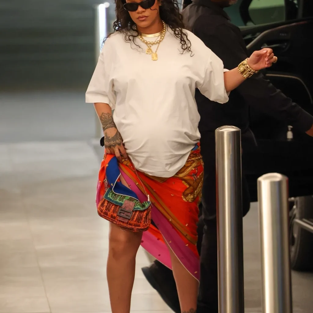 Rihanna strutting in a scarf-as-skirt maternity look, redefining pregnancy fashion.