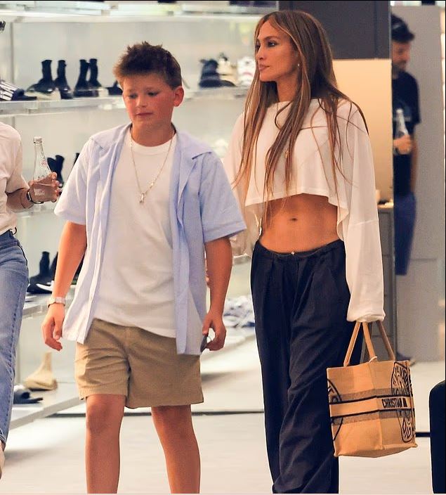 Jennifer Lopez Sparks Backlash Over Midriff-Baring Outfit While Shopping with Ben Affleck’s Teen 1 Jennifer Lopez shows off toned abs in white crop top and black trousers on Beverly Hills shopping trip with Ben Affleck’s son.
