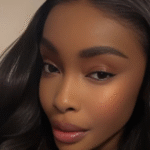 Somtochukwu Maduagwu, ARISE TV anchor, smiling professionally on air.