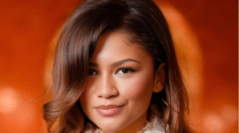 Zendaya at Paris Fashion Week with retro bouffant hairstyle in metallic Louis Vuitton mini dress.