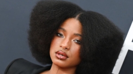 Willow Smith wearing a stacked braided updo and frosty baby-blue eyeshadow at Dior Paris Fashion Week