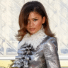 Zendaya Stuns in a Pantsless Metallic Louis Vuitton Look at Paris Fashion Week! 5 Zendaya pantless in metallic Louis Vuitton mini coat dress with bouffant hair at Paris Fashion Week Louvre show