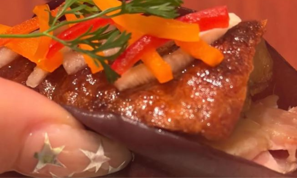 Dua Lipa’s Star Nails Are the Perfect Holiday Nail INSPO You Need 8 Dua Lipa showing peachy-pink nails with silver star accents, perfect holiday nail inspiration