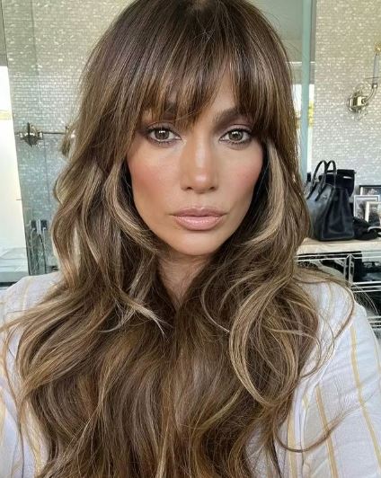 25 Iconic Celebrity Curtain Bangs Styles That Always Look Amazing 19 Jennifer Lopez glamorous curtain bangs