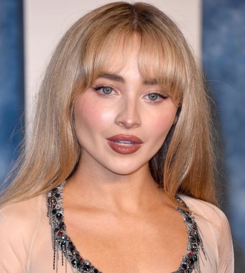 25 Iconic Celebrity Curtain Bangs Styles That Always Look Amazing 15 Sabrina Carpenters curtain bangs are soft feminine and full of movement
