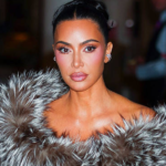 Kim Kardashian coquette hairstyle with ivory bow for holiday event