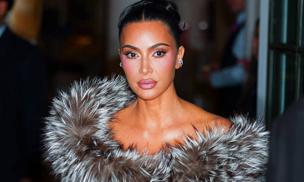 Kim Kardashian coquette hairstyle with ivory bow for holiday event