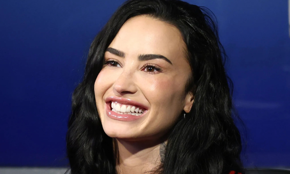 Demi Lovato sparkly modernist holiday manicure with almond-shaped nude nails and multicolored gemstone accents