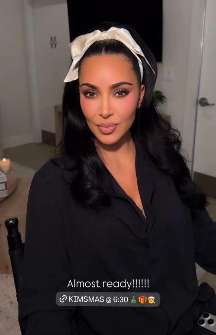 Kim Kardashian coquette hairstyle with ivory bow for holiday event