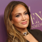 Jennifer Lopez wearing a red spaghetti-strap dress at Christmas dinner, showcasing her festive holiday glam and classic J.Lo style