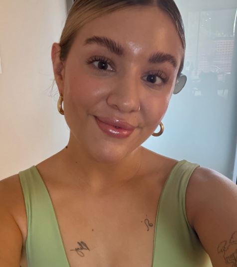 Minimalist skinimalism skincare routine layout with five essential products including cleanser, serum, moisturizer, toner, and sunscreen.