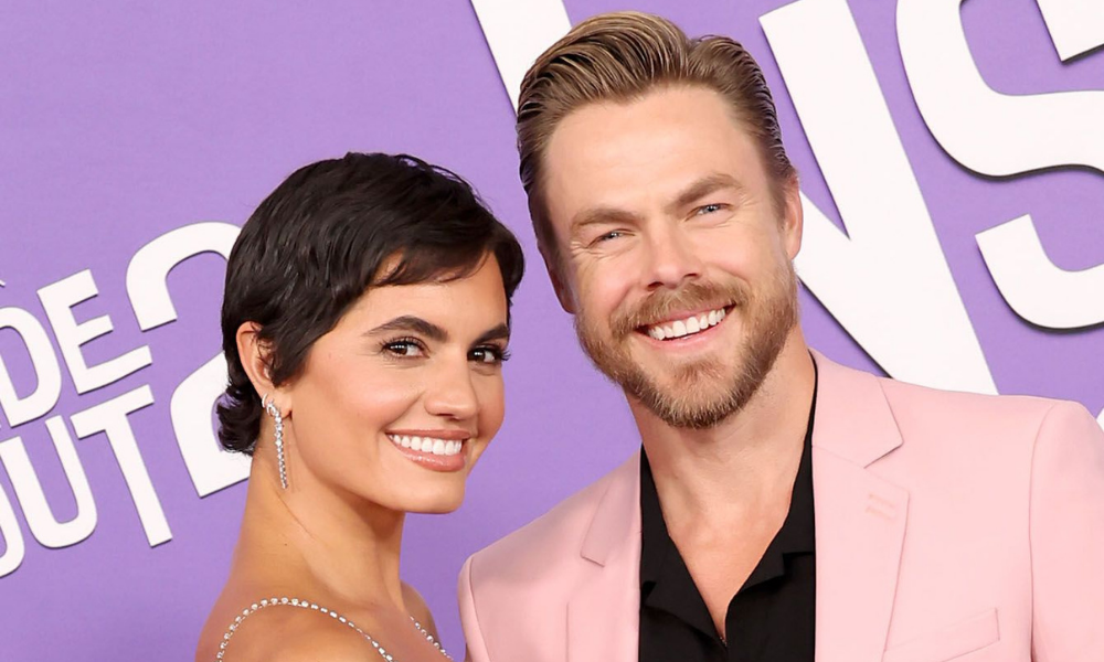 Hayley Erbert and Derek Hough holding their newborn daughter Everley Capri after her birth