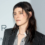 Kristen Stewart wearing a sheer sequin naked dress styled with a bomber jacket and platform boots in winter