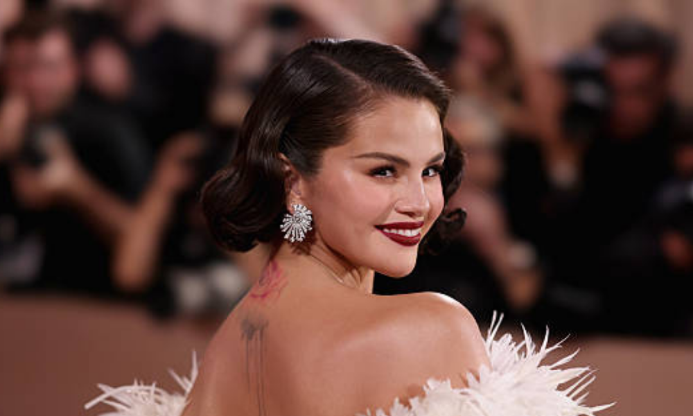 Selena Gomez showing off metallic bronze shimmer nails with a glossy, sun-kissed finish during winter