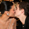 Timothée Chalamet and Kylie Jenner seated together at the Golden Globes during a tense viral moment before their awkward kiss