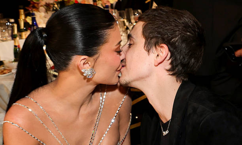 Timothée Chalamet and Kylie Jenner seated together at the Golden Globes during a tense viral moment before their awkward kiss