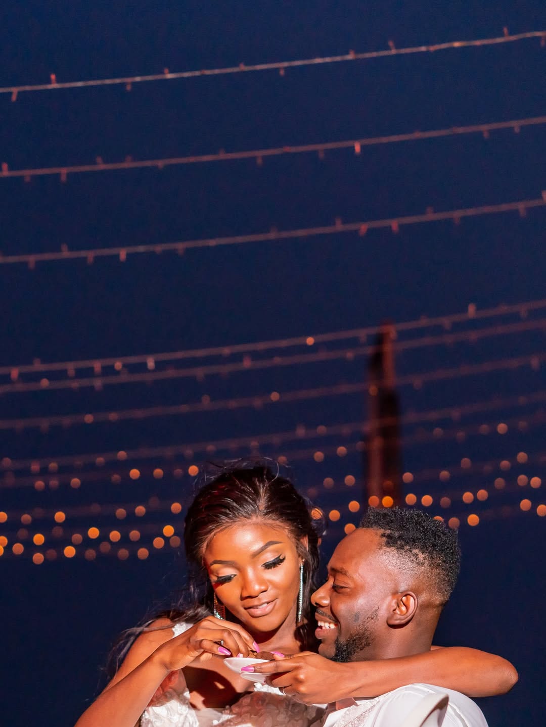 Adekunle Gold and Simi celebrating their 7th wedding anniversary after welcoming twins