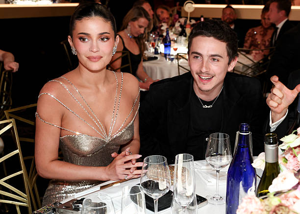 Timothée Chalamet and Kylie Jenner sitting side by side at Golden Globe 2026