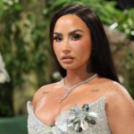 Demi Lovato outline manicure with nude base and thin black edges on short nails at Grammys after-party